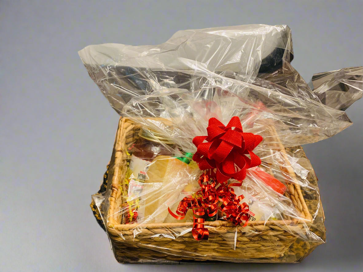 Gift basket with a red bow on a table