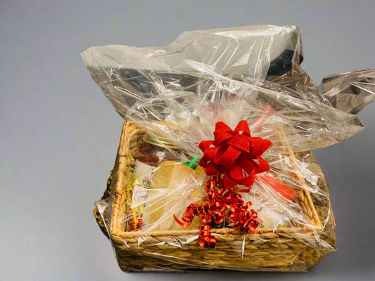 Gift basket with a red bow on a table